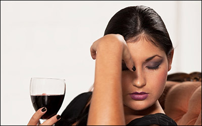 Girl with red wine is taking hard decision